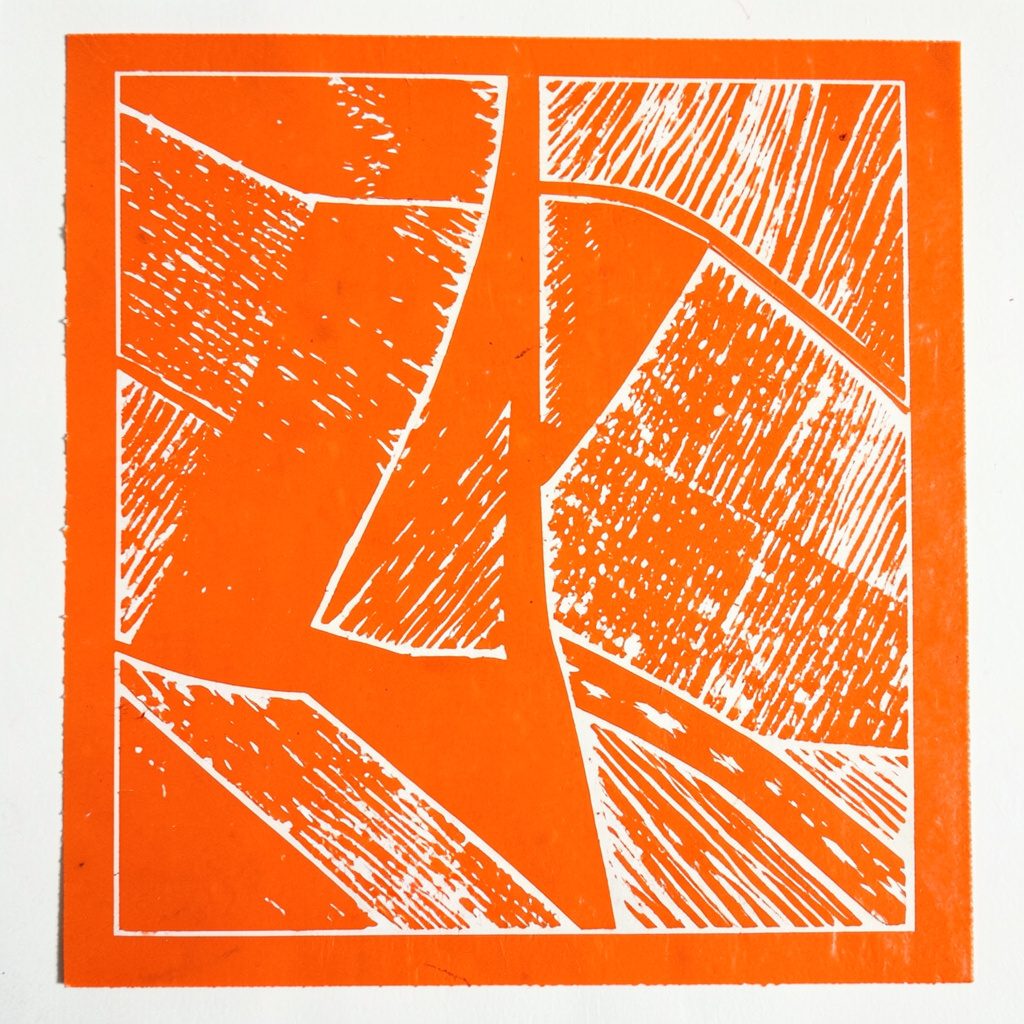 A carved linocut relief print of a captain's armband and strategy board, using warm ochre, midnight blue, and ivory highlights in a bold graphic style.