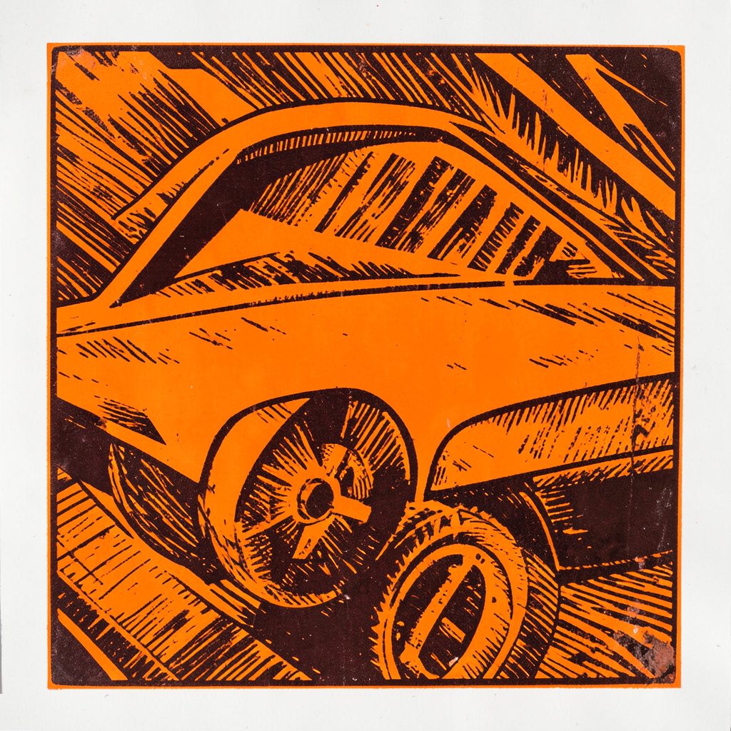 A carved linocut relief print of a keyboard and mouse on a desk with a glowing monitor in the background, using deep indigo, warm amber, and slate gray tones in a contemplative nighttime scene.
